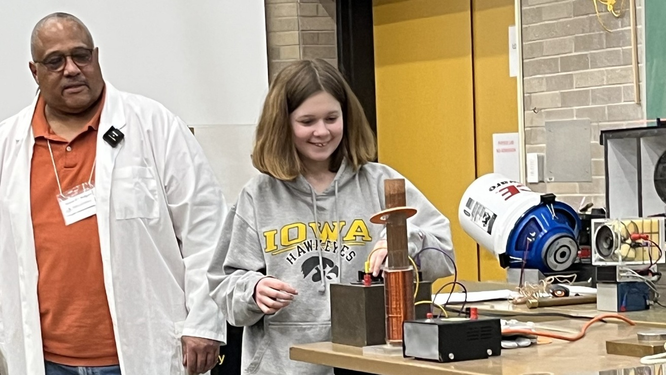 Vincent Rodgers showing a student a physics demo